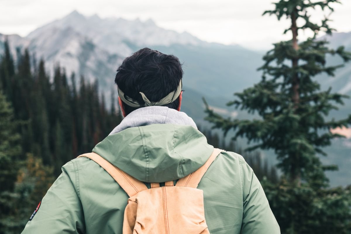 Person in a rain jacket with a small daypack outdoors