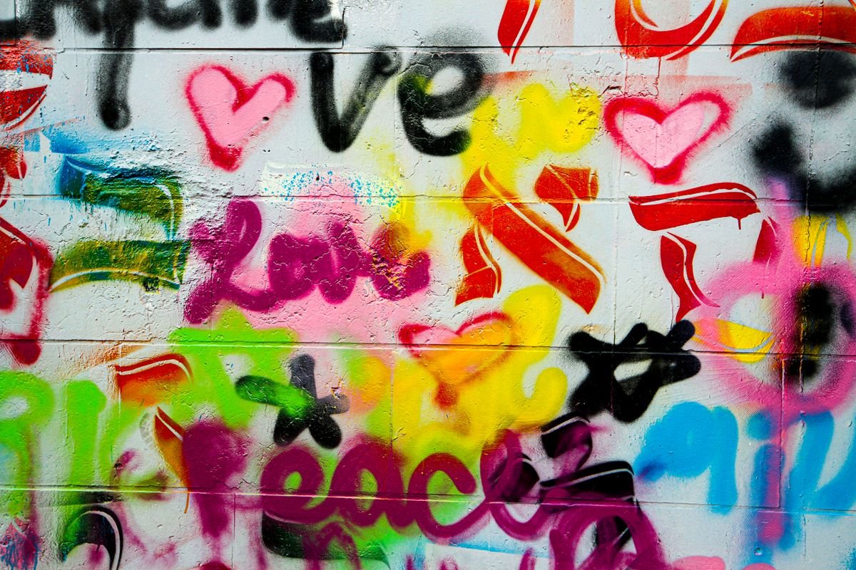 A Belfast peace wall covered in murals and signatures
