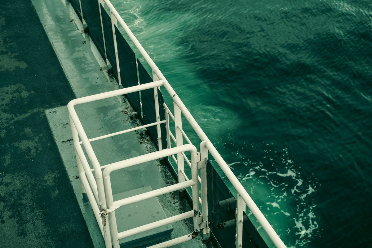 Ferry deck railing over open sea water