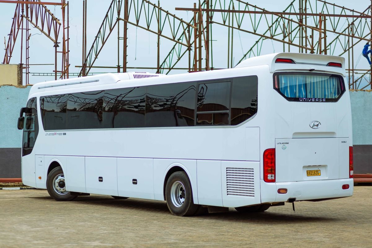 A white touring coach parked outside