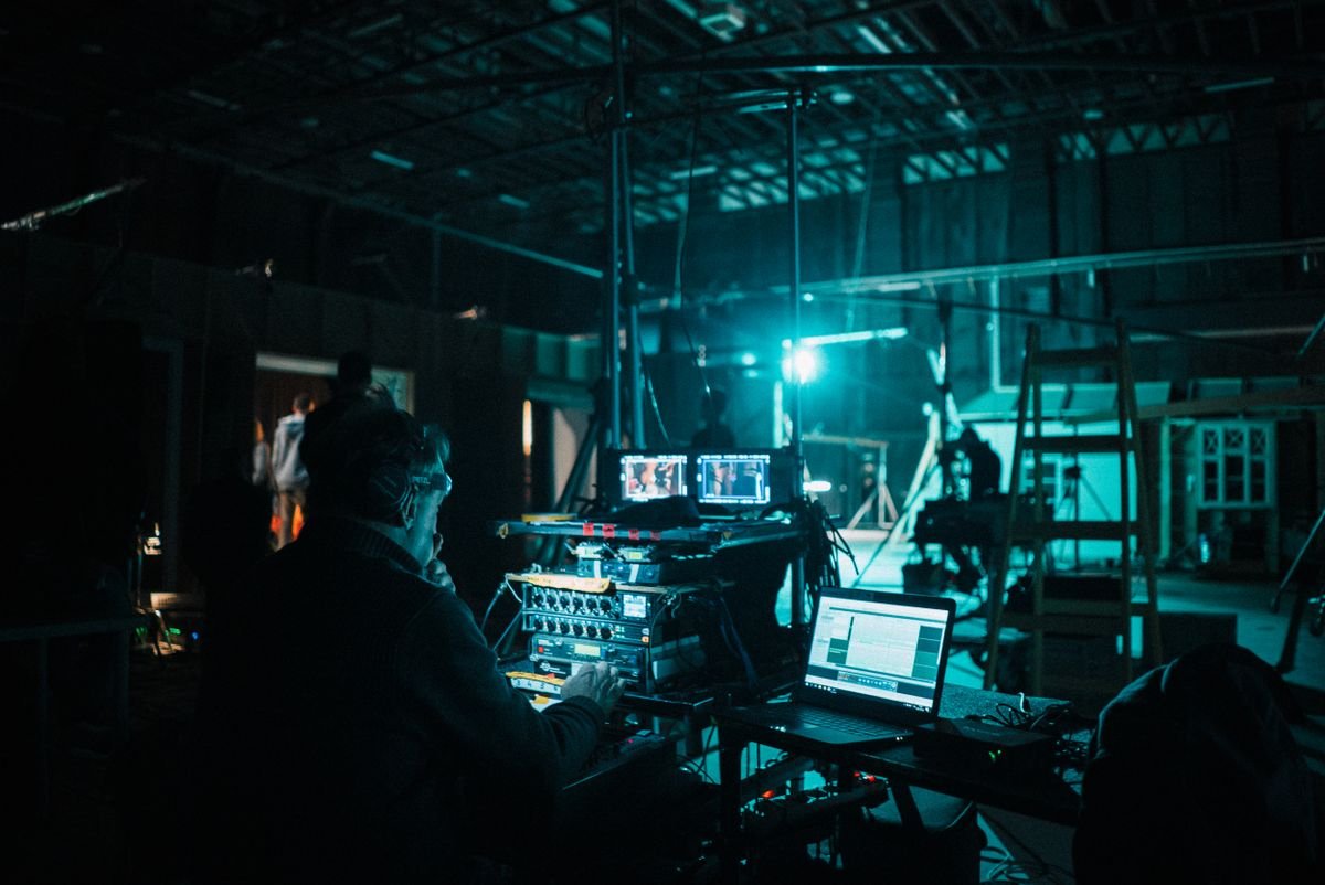 Film set lighting rigs and monitors on an indoor soundstage