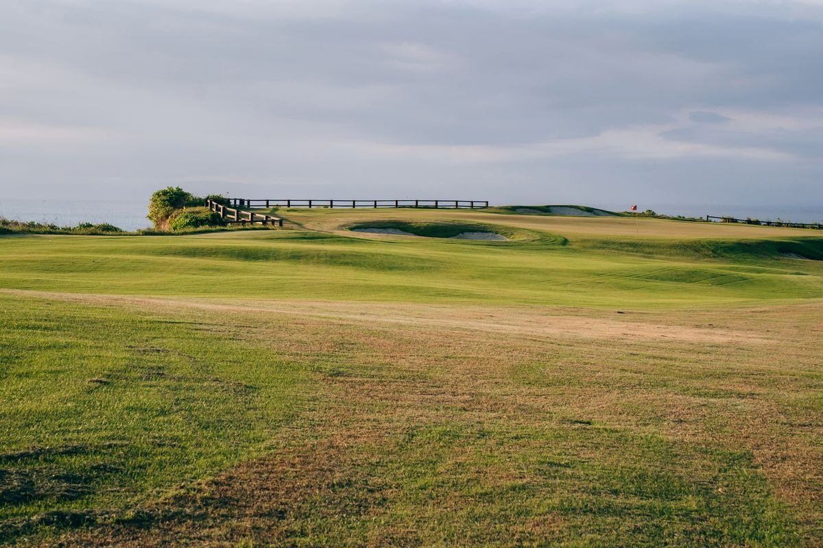 Wide coastal links fairway rolling toward the sea