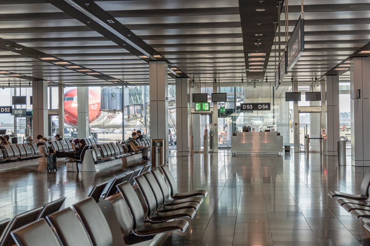 Airport terminal gate area with a plane waiting outside