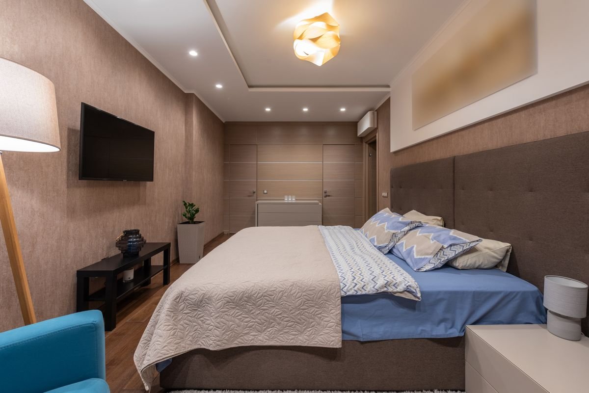 Warm guesthouse bedroom with a made bed and soft lighting