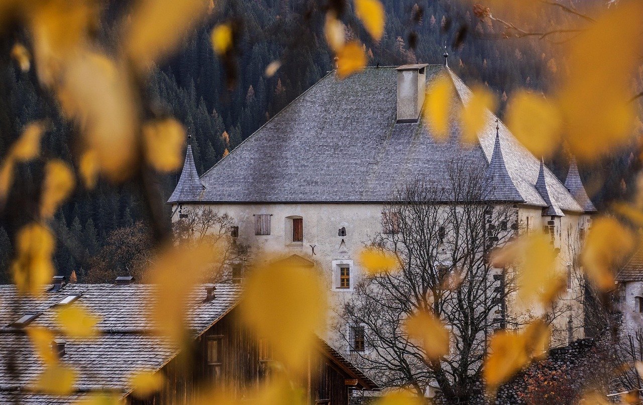 Gothic castle framed by autumn leaves