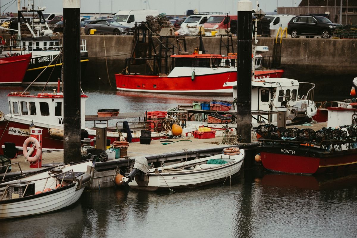 Fishing boats and lobster pots in Howth working harbour in County Dublin
