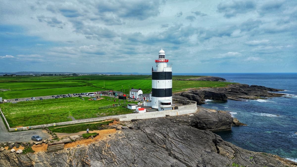 Hook Head Lighthouse with black and white bands on a rocky headland in County Wexford