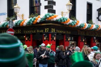Temple Bar pub in Dublin decorated with Irish flag balloons and a St Patricks Day crowd