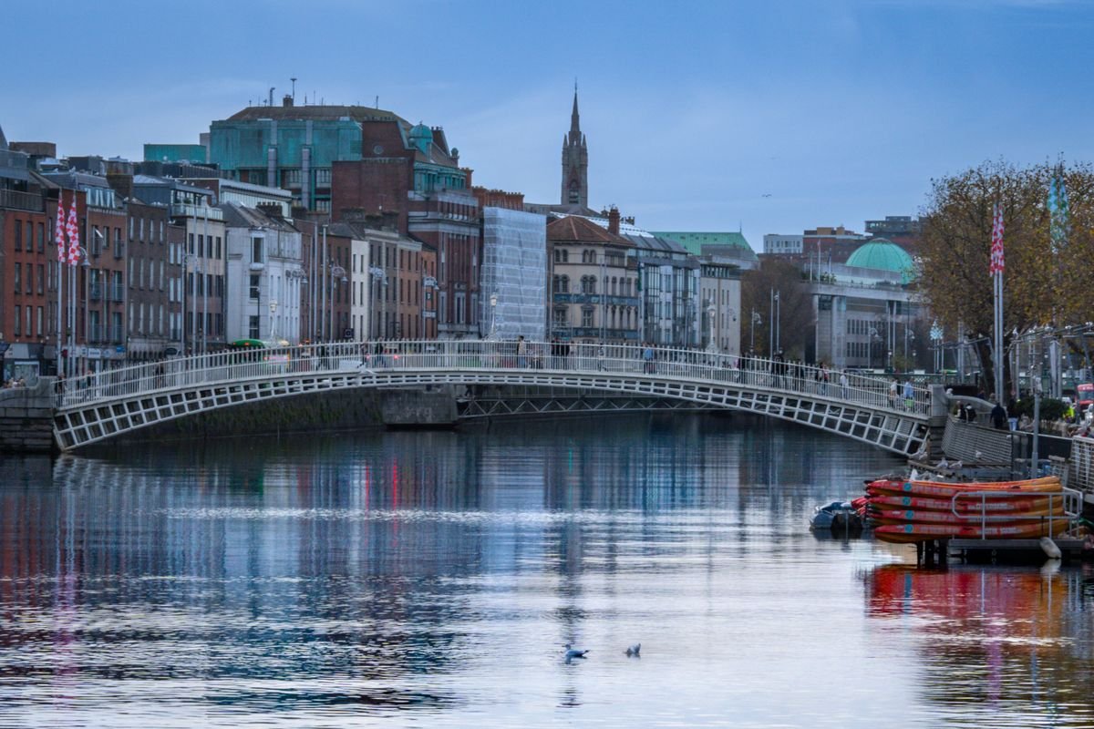 The white cast-iron arch of the Ha'penny Bridge over the River Liffey in Dublin