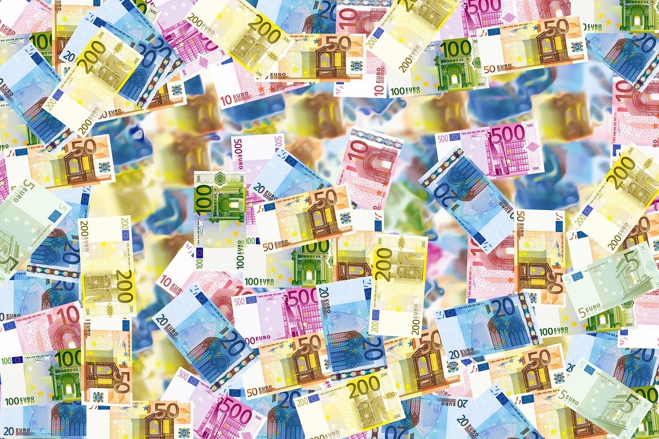 Scattered euro banknotes representing the cost of a week of golf in Ireland