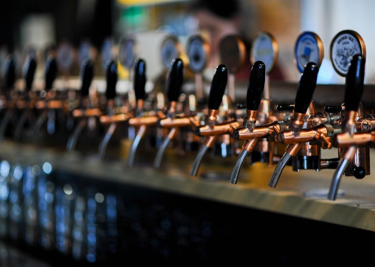 Row of beer taps at a pub bar