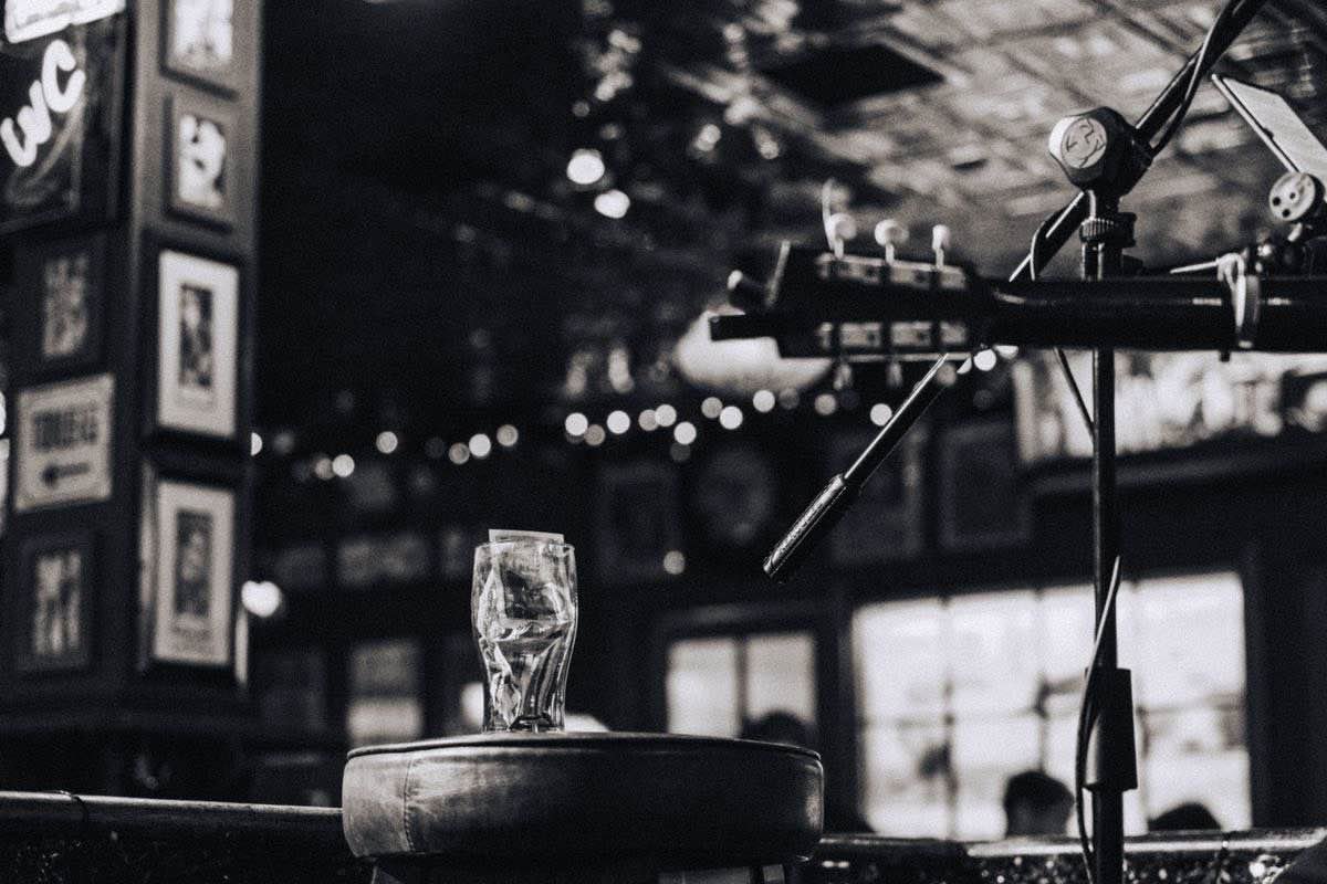Guitar and microphone set up on a small stage in a Dublin pub