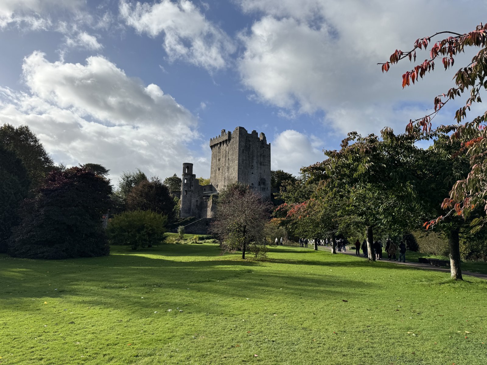 Blarney Castle tower above the lawns with autumn trees turning colour