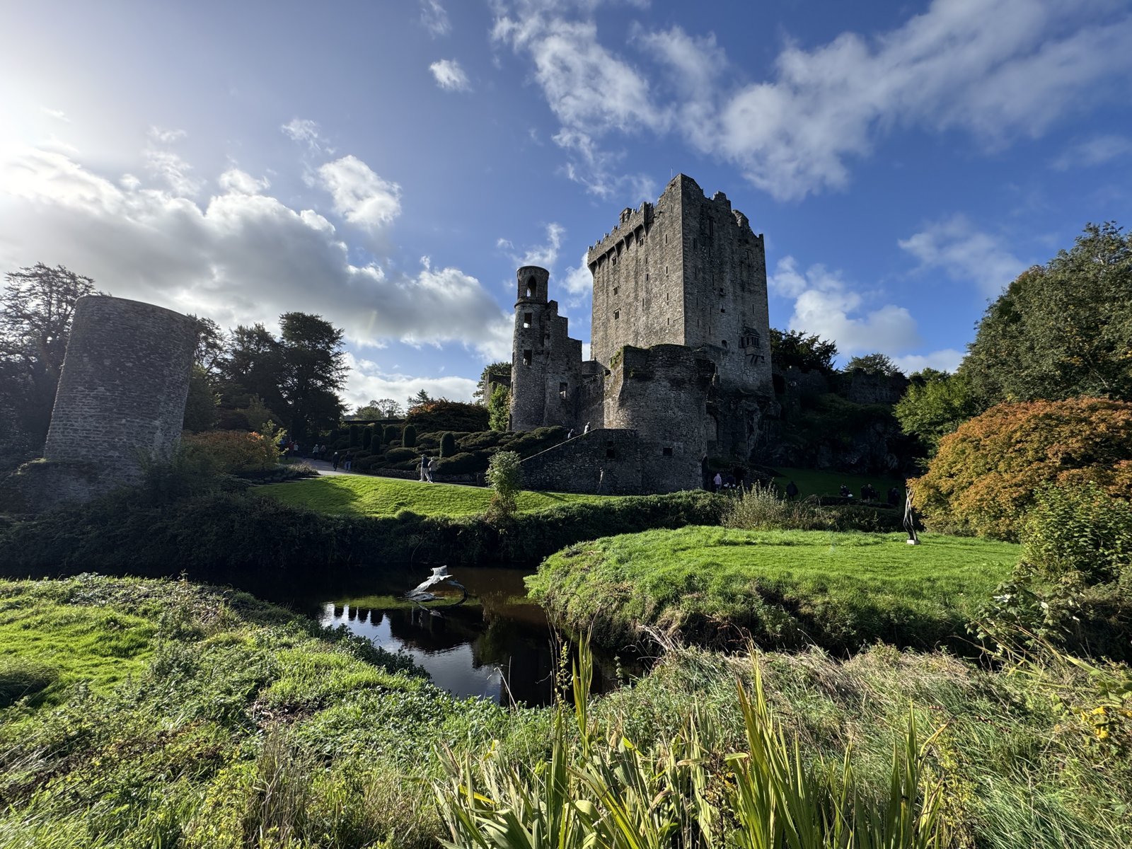 Blarney Castle tower rising above the pond and green grounds near Cork