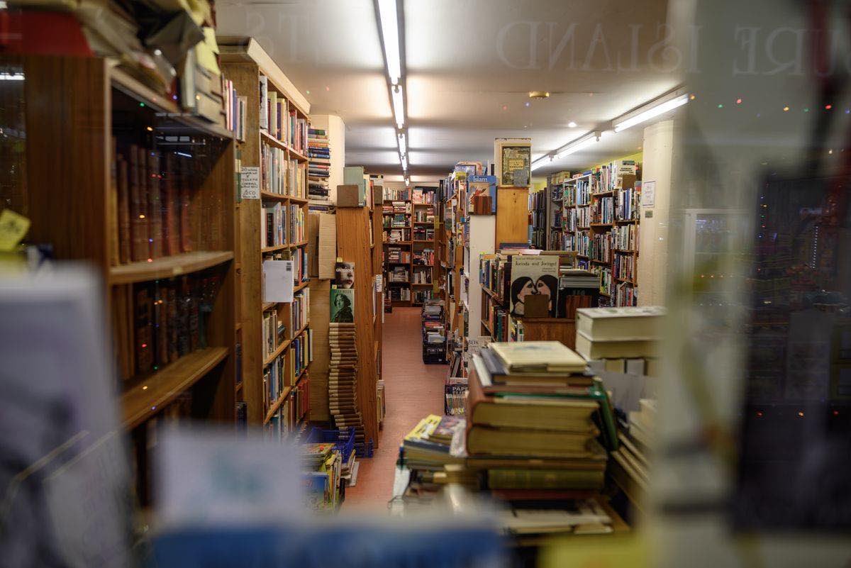 The interior of a sprawling independent bookshop, shelves packed floor to ceiling with new and used books