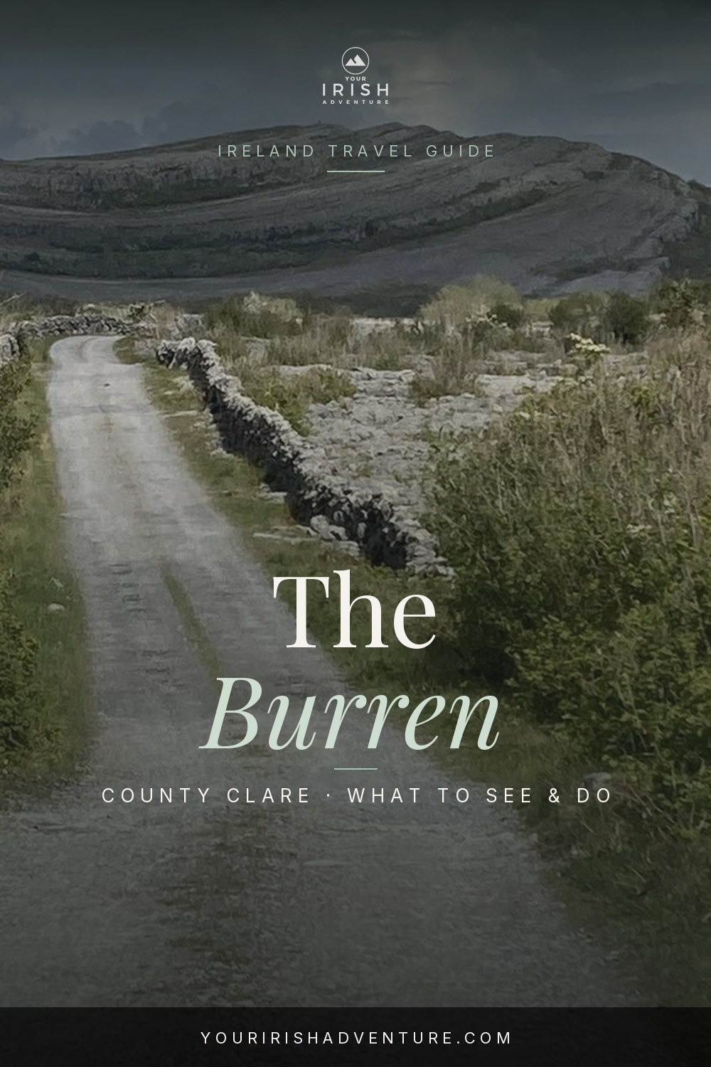 Grey limestone pavement of the Burren stretching to hills under a cloudy sky in County Clare Ireland