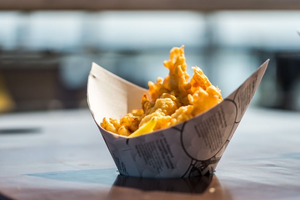 Battered fresh fish in a paper takeaway box