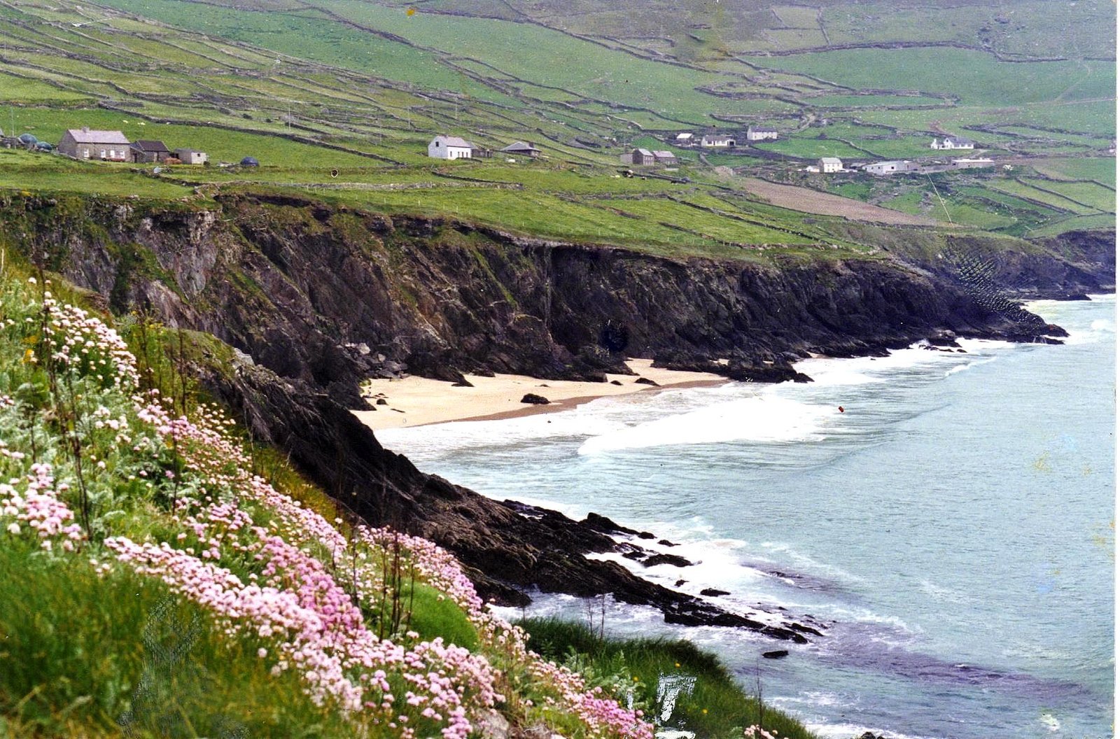 Small beach ringed by dark cliffs at Coumeenoole under Slea Head