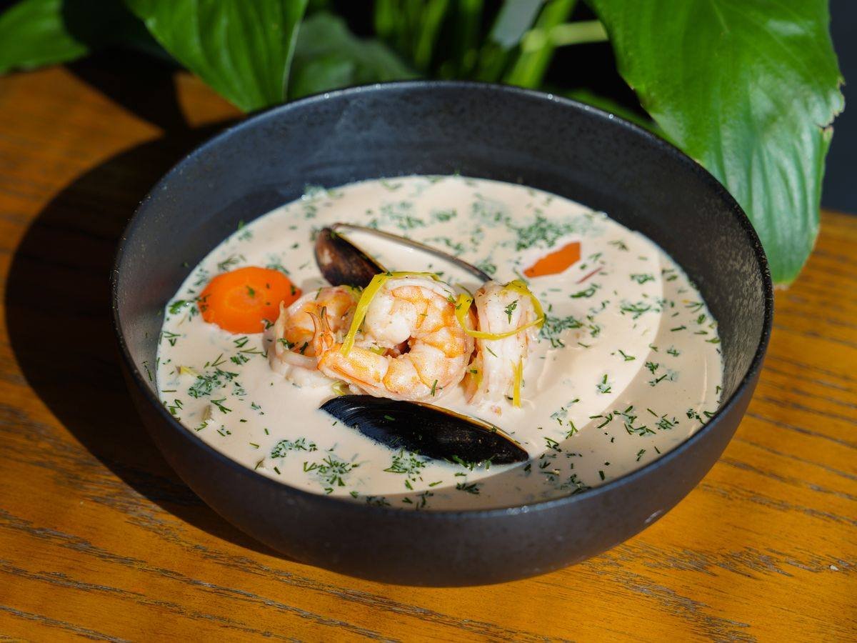 A bowl of creamy seafood chowder with shrimp and mussels