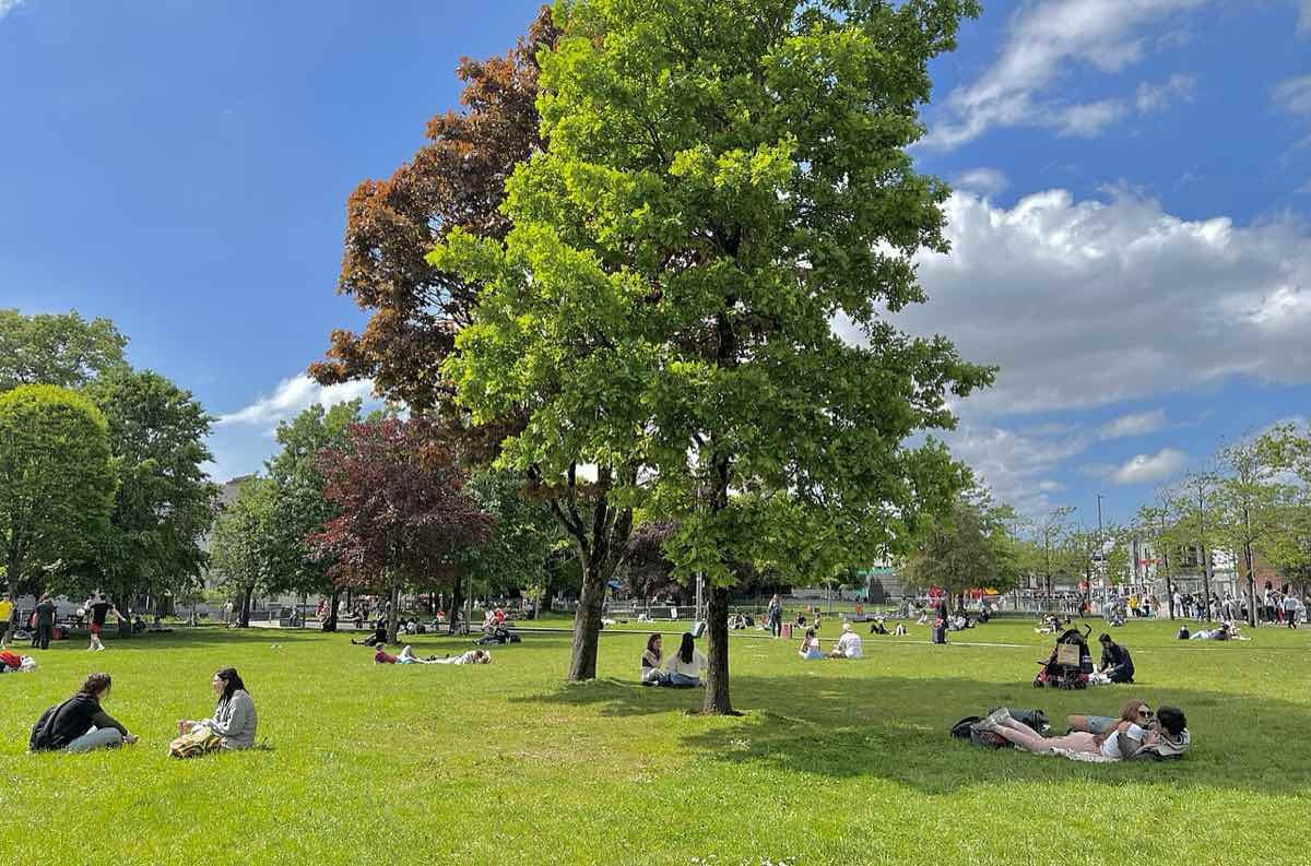 Eyre Square, the central green park in Galway City, with people out on the grass