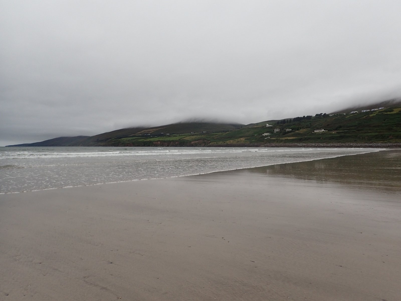 Wide flat sand at Inch Beach with mountains behind on the Dingle Peninsula