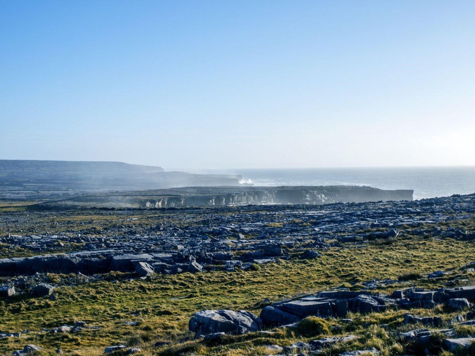 Low limestone terraces and cliffs along the Inishmore coastline with the Atlantic beyond