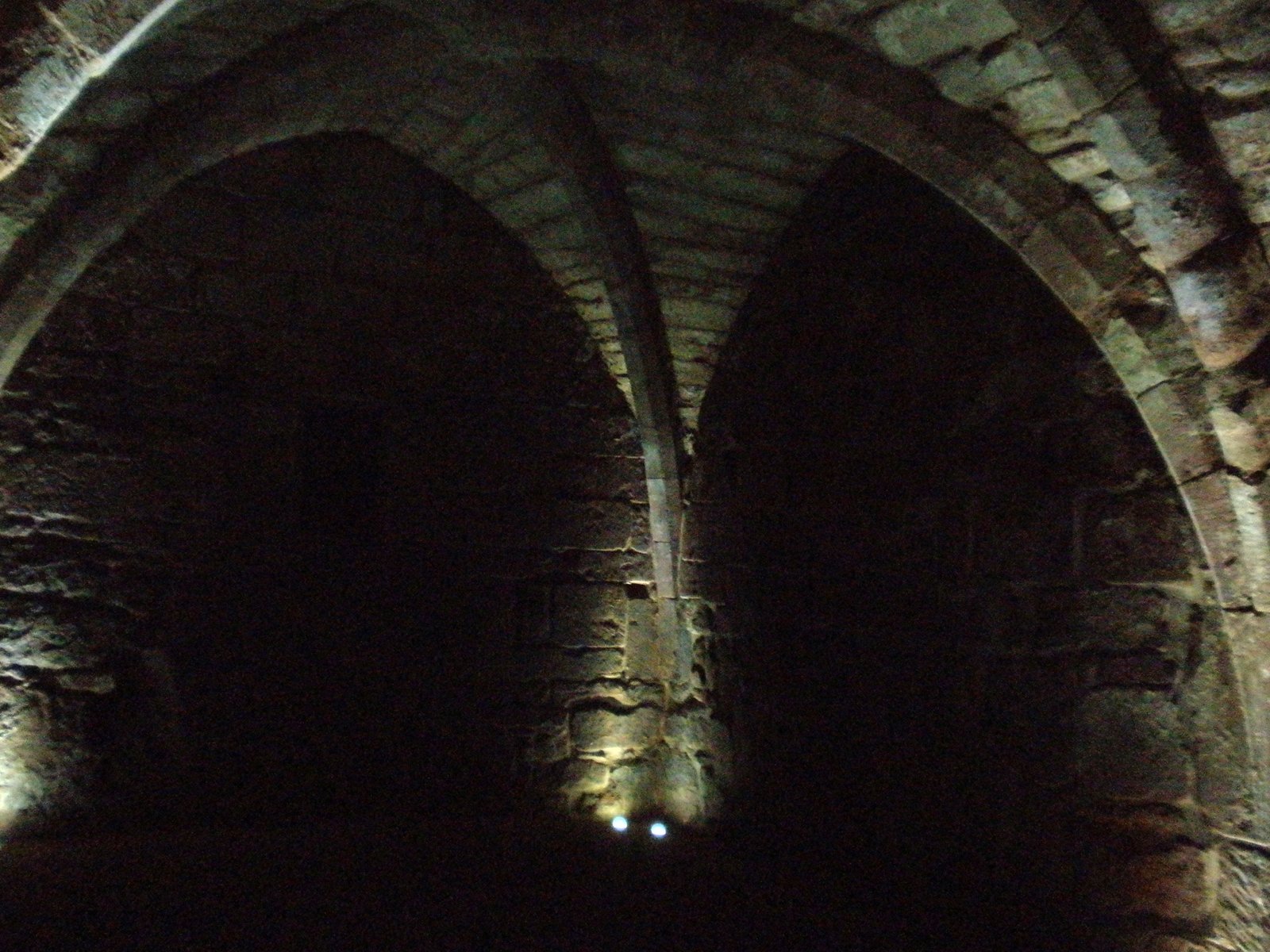 Dark medieval stone vaulted undercroft