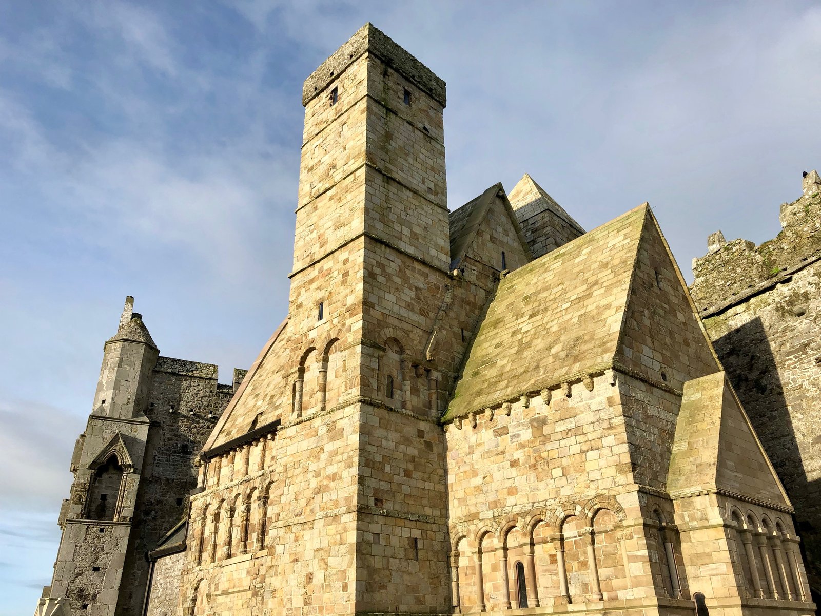 The Romanesque stonework and square towers of Cormac's Chapel at the Rock of Cashel