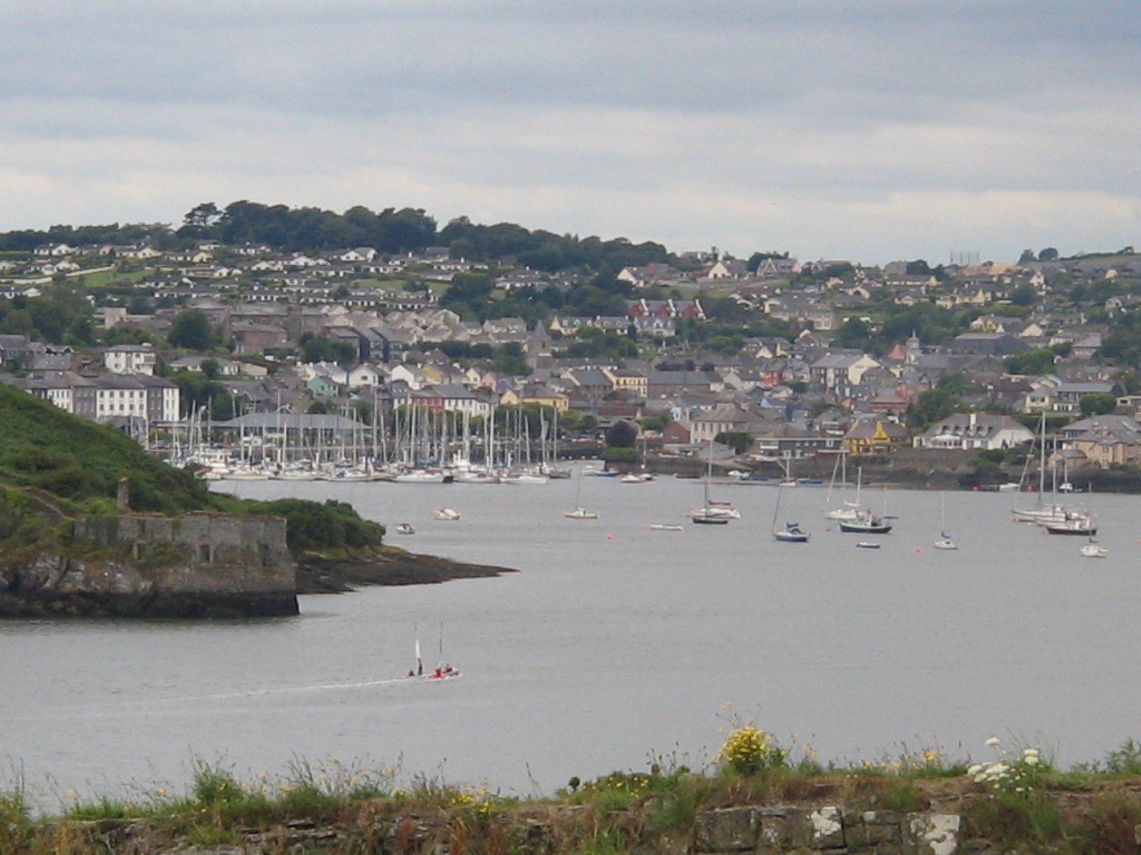 Kinsale harbour with yachts and painted houses climbing the hill in County Cork
