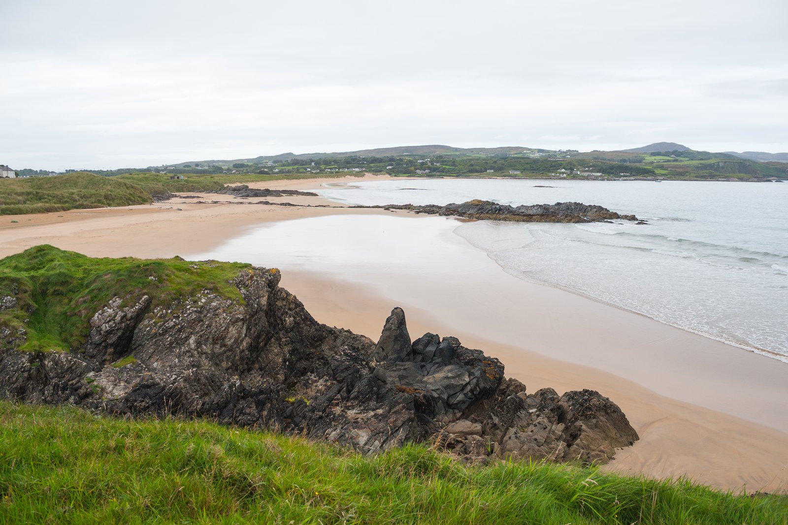 Rocky headland and wide sandy bay at Culdaff on the Inishowen peninsula