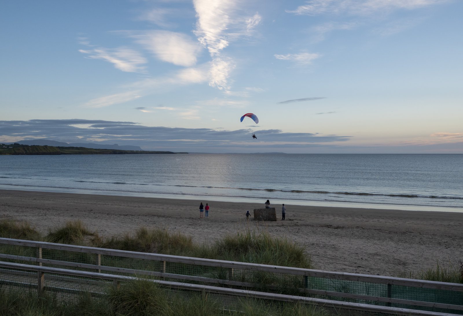 A paraglider over the wide flat strand at Rossnowlagh, County Donegal