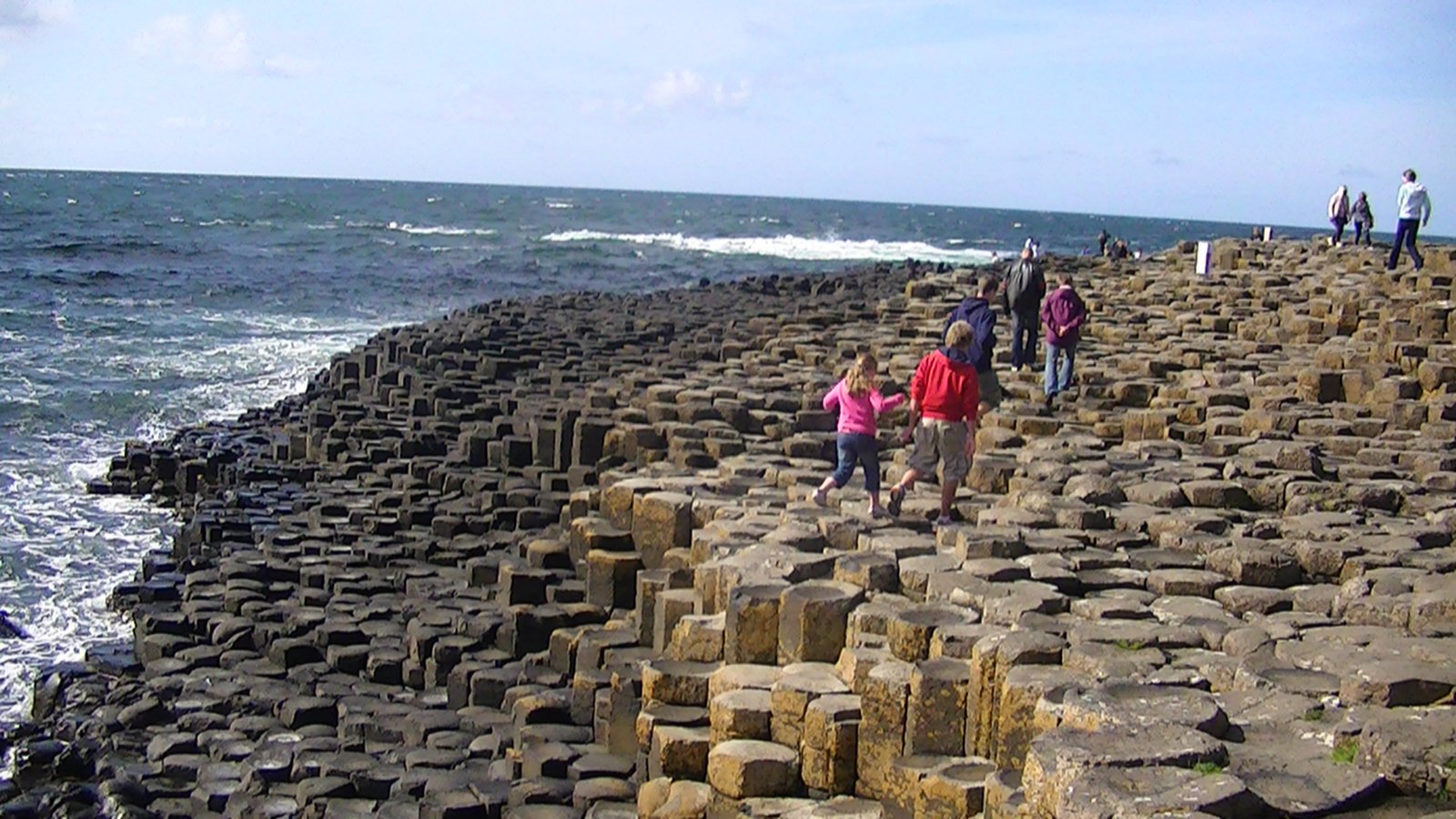 People on the hexagonal basalt stones of the Giant's Causeway