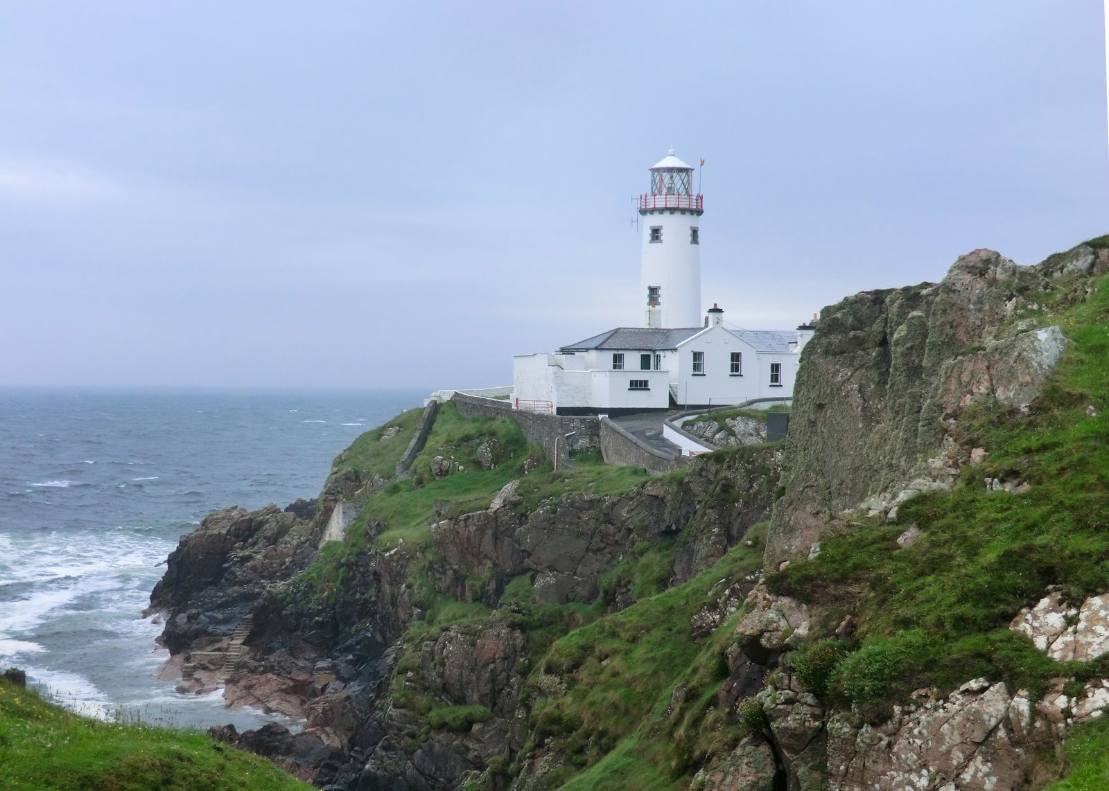 White Fanad Head Lighthouse on a rocky Donegal headland above the sea