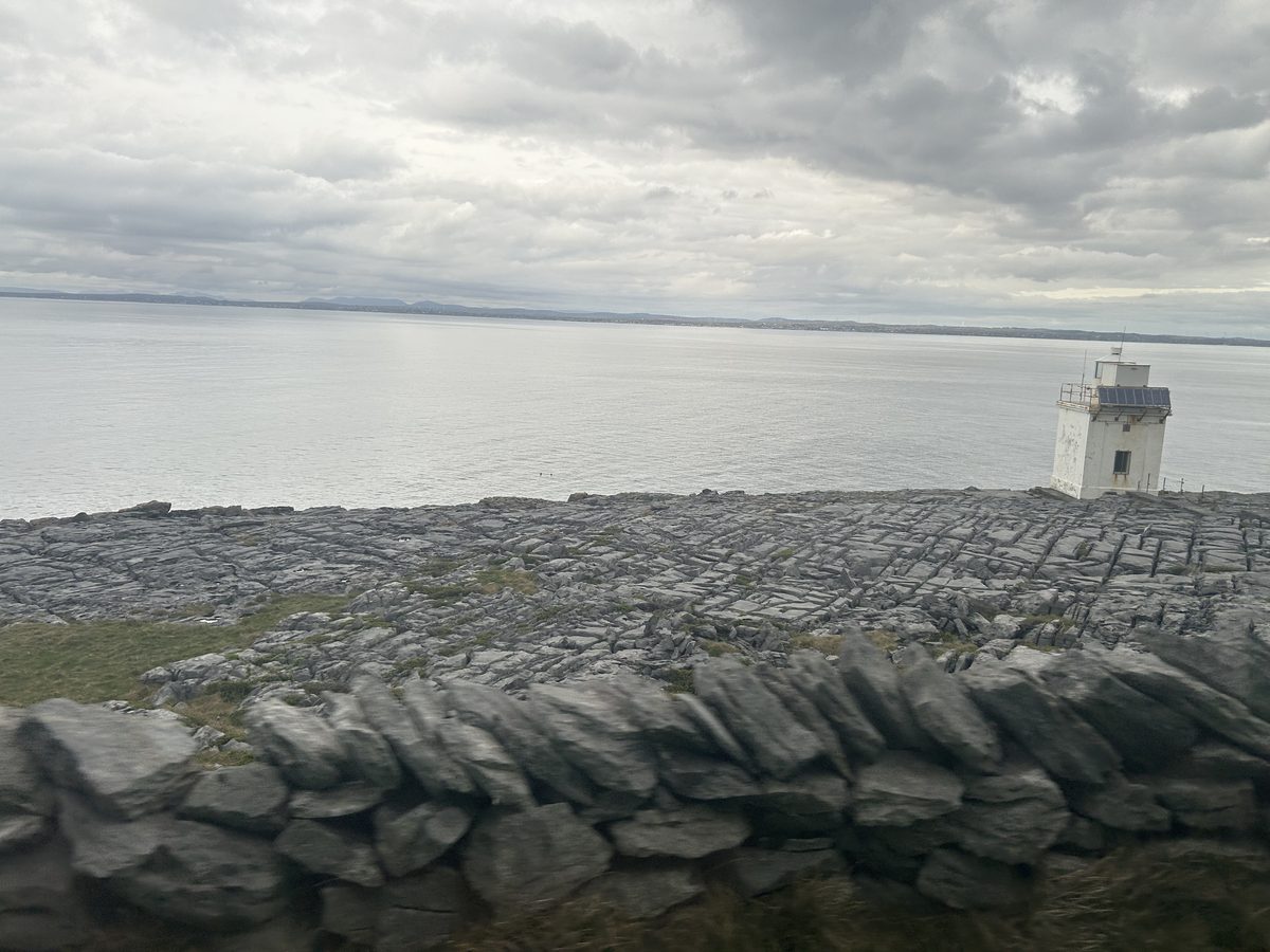 Burren limestone pavement above the Atlantic with Black Head lighthouse
