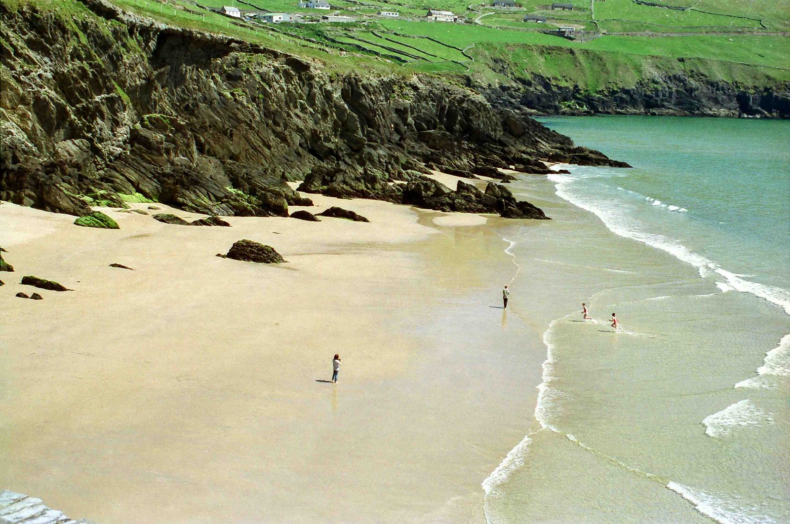 The sandy cove of Coumeenoole Beach backed by cliffs on the Slea Head road