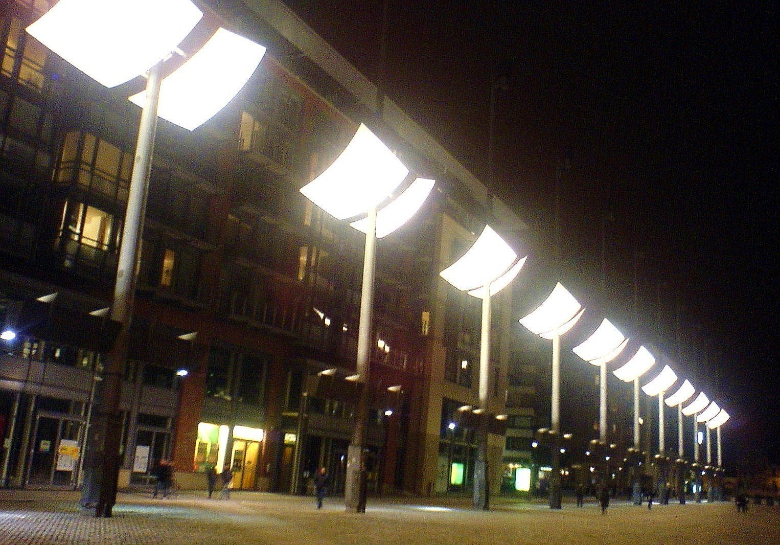The tall lighting masts of Smithfield Square in Dublin at dusk