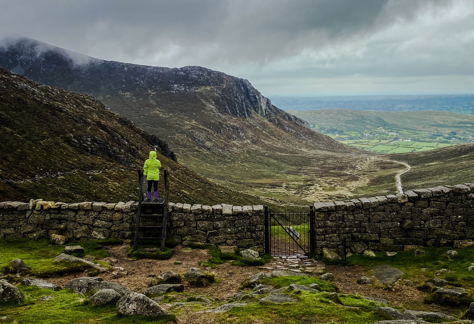 A walker at the stile above Hare's Gap in the Mourne Mountains