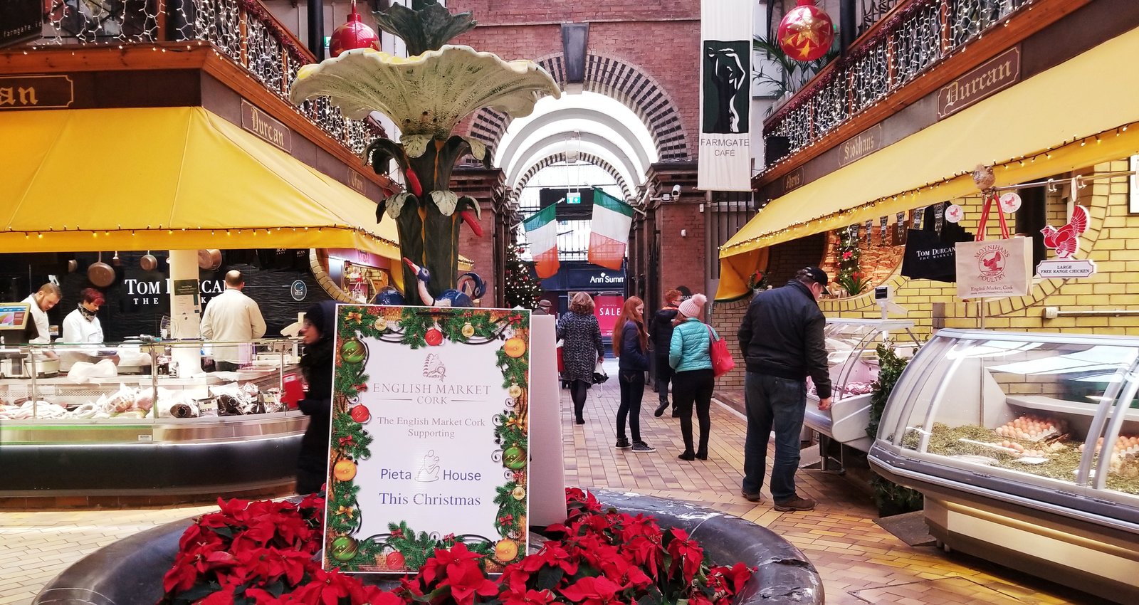 Inside the English Market in Cork with food stalls and the ornate fountain