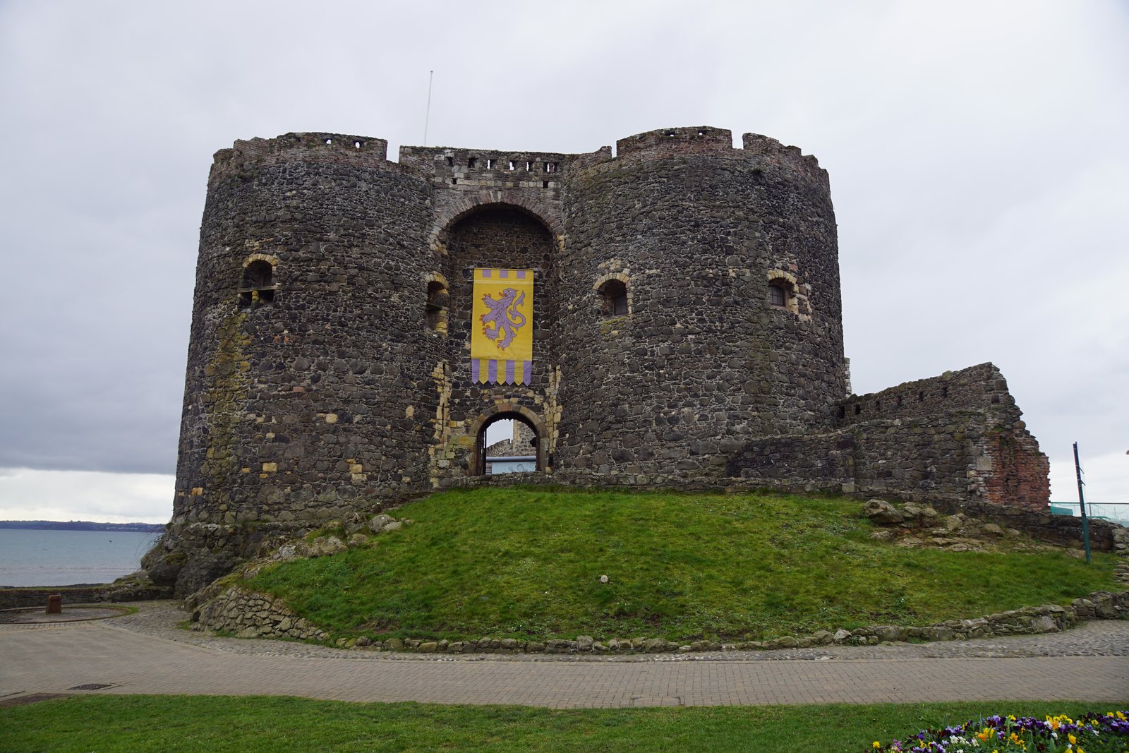 The stone gatehouse and keep of Carrickfergus Castle beside Belfast Lough