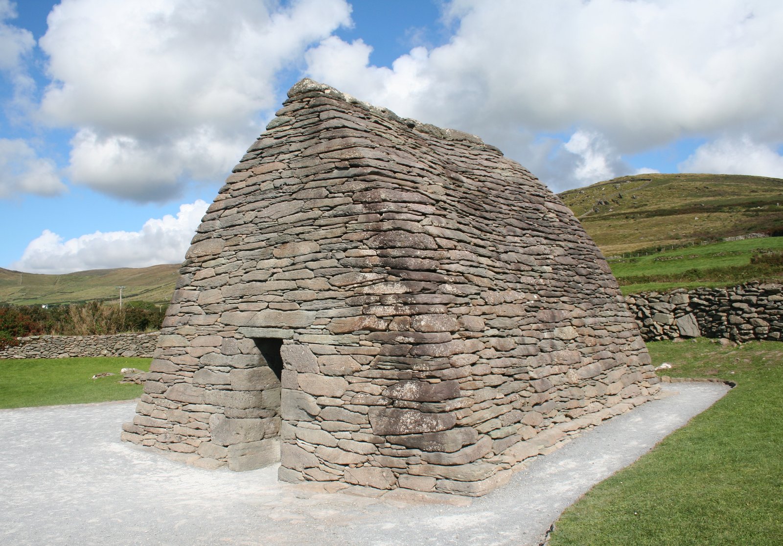 The dry-stone Gallarus Oratory under a blue sky on the Dingle Peninsula