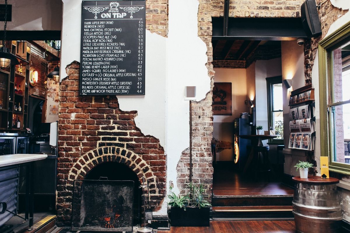 Rustic pub interior with an old brick fireplace nook