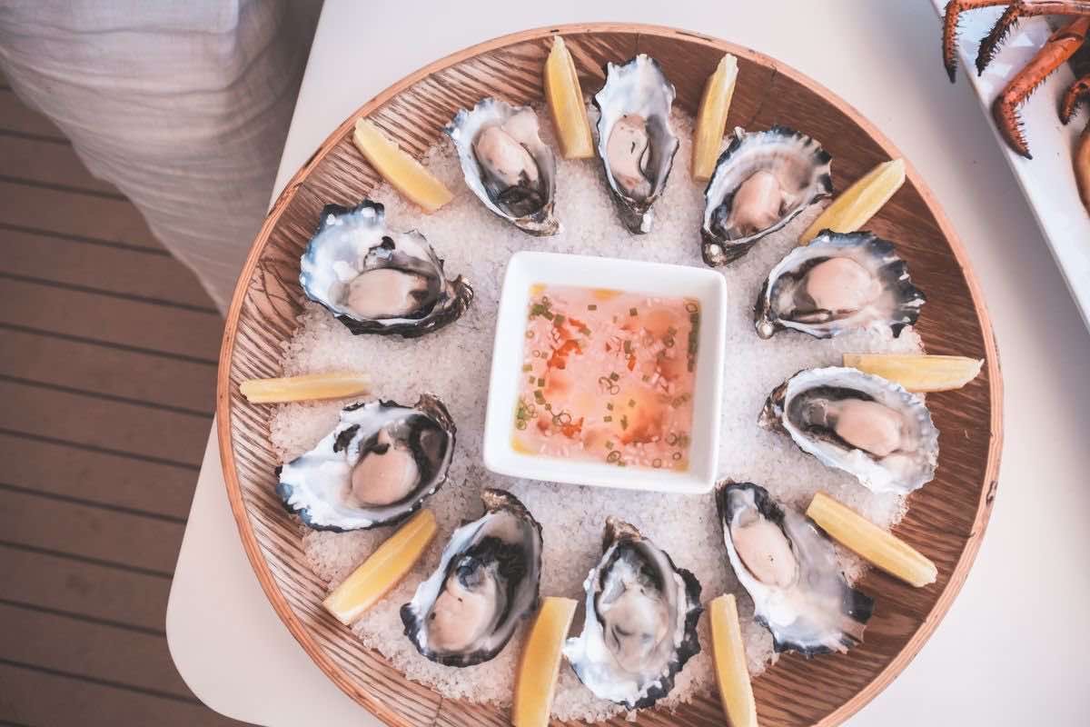 Fresh shucked oysters on ice with lemon