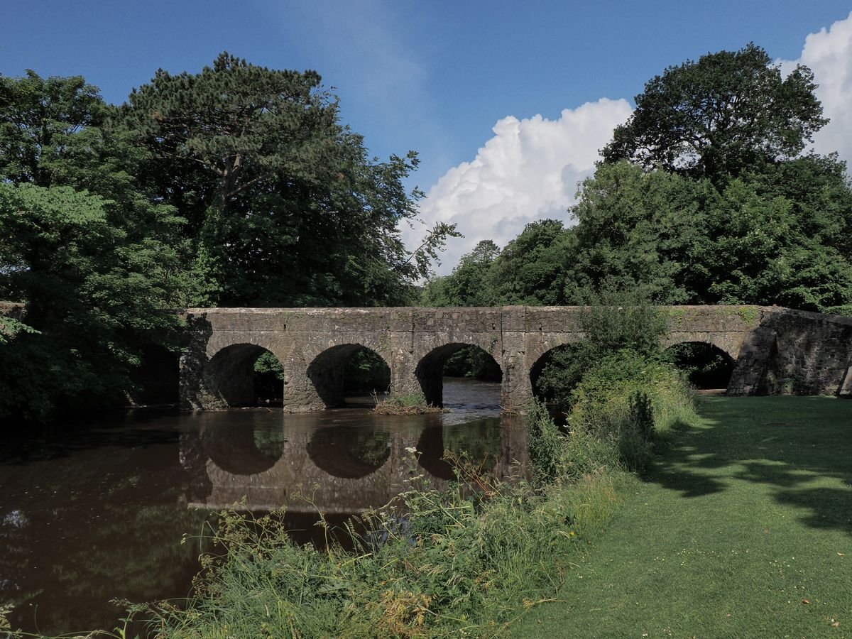 Stone arch bridge over a river at Tollymore Forest Park in Northern Ireland