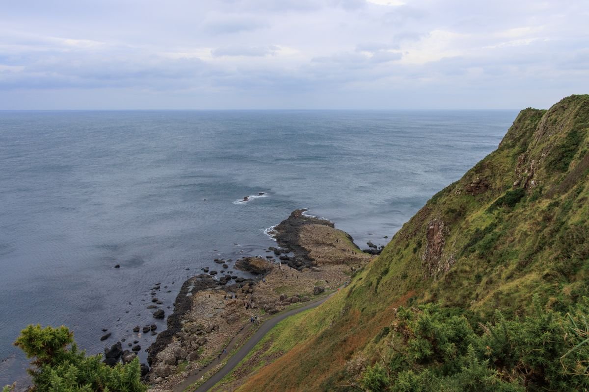A narrow coastal path running along steep basalt sea cliffs on the Islandmagee coast