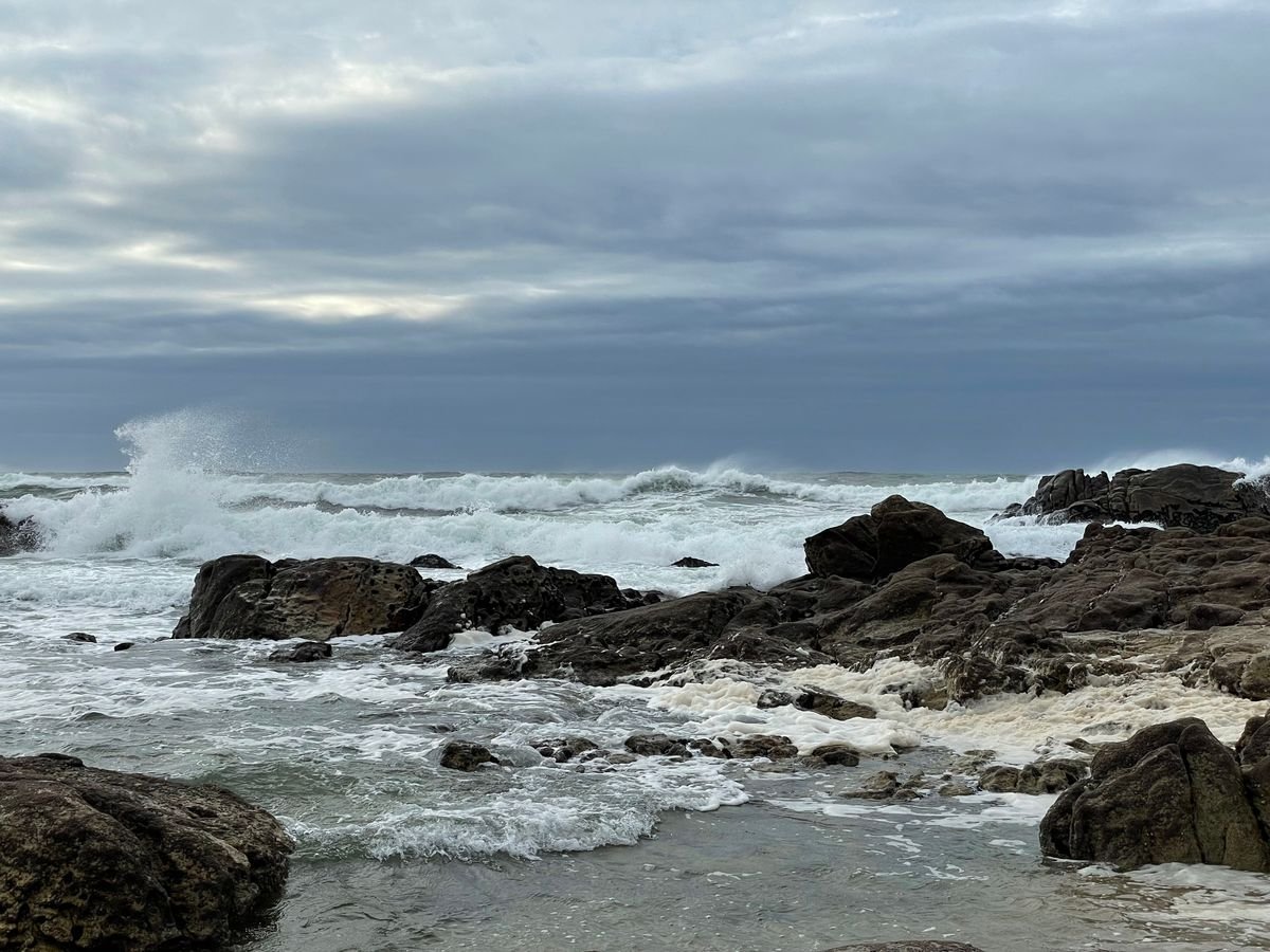 Waves crashing on a rocky Kerry coast under a grey winter sky