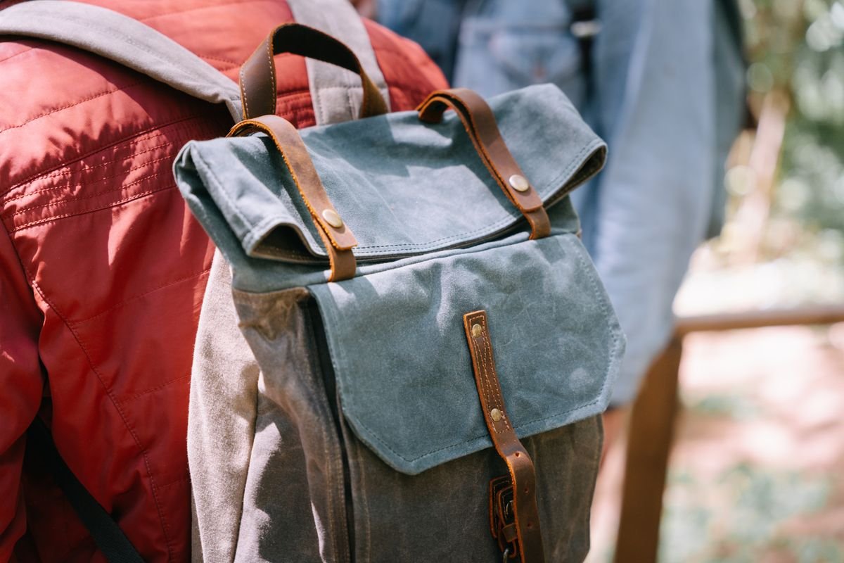 A canvas daypack worn on someone's back