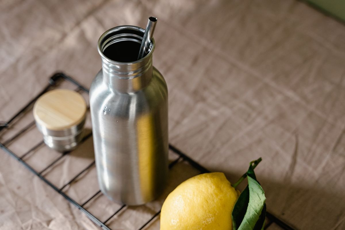 Stainless steel reusable water bottle with a metal straw
