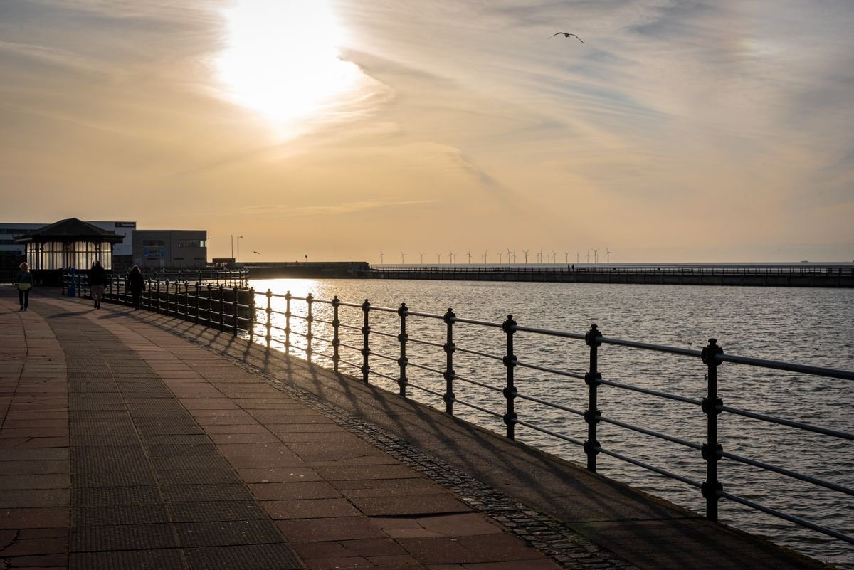 The seafront promenade along Galway Bay with railings and a walkway