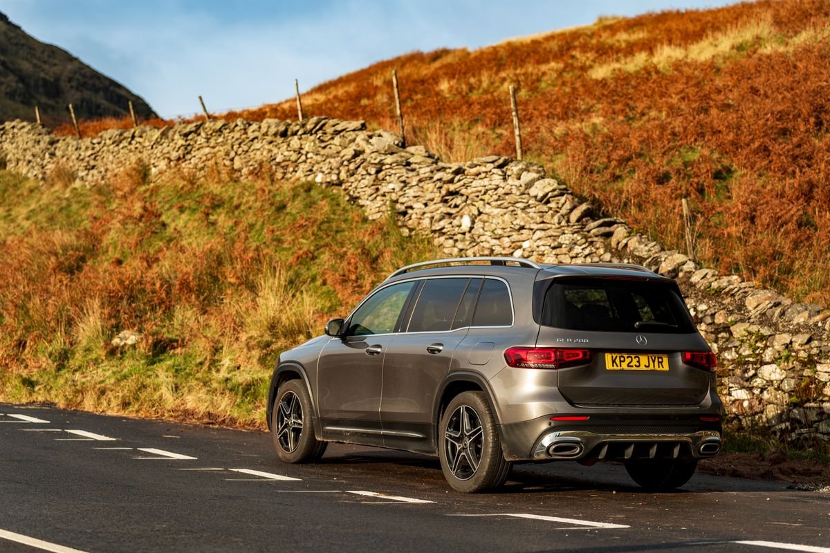Car on a narrow rural Irish road with stone walls