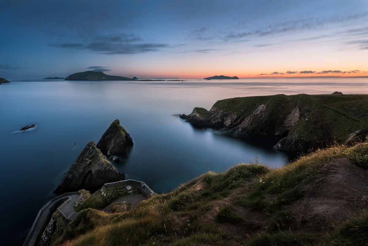 Dunquin pier at sunset with the Blasket Islands on the horizon